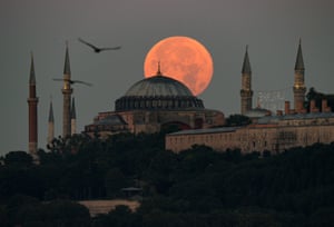 Istanbul, Turkey. A full moon rises over the Hagia Sophia Grand Mosque and Blue Mosque in Istanbul
