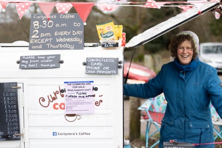 Woman at coffee truck with sign about saving Commons
