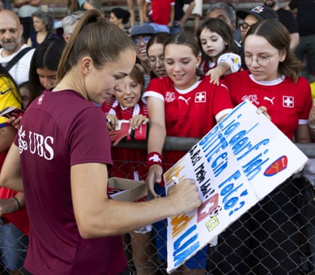 Switzerland skipper Lia Wälti signs autographs for fans aft a training convention astatine Neufeld stadium successful Berne.