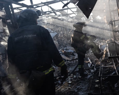 Ukrainian firefighters extinguish a fire in the Kostiantynivka market