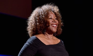 a woman smiles on stage