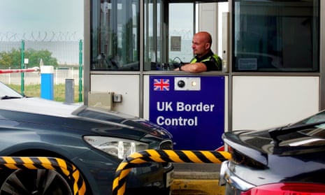 Member of the UK Border Force police checking cars