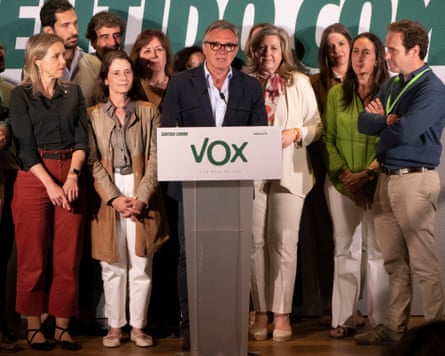 Manuel Gavira speaks at a lectern with Vox members standing beside him