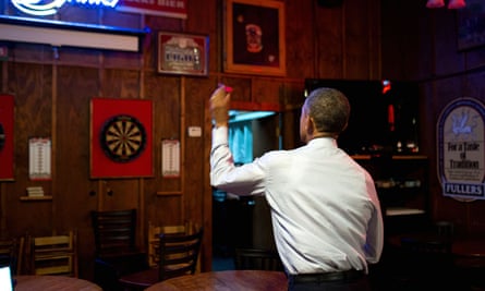 President Barack Obama throws darts at Manuel’s Tavern in Atlanta on 10 March 2015.