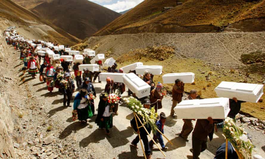 Relatives of victims killed in a 1980s army massacre in southern Peru carry their coffins during a burial ceremony at the village of Putis in the outskirts of Ayacucho in 2009.