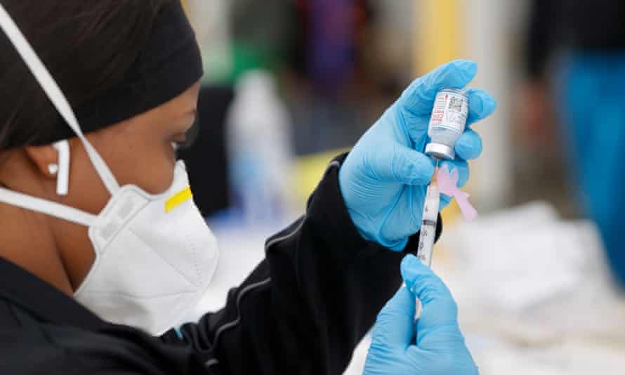 A health worker prepares the Moderna COVID-19 vaccine in Morgan Hill, California.