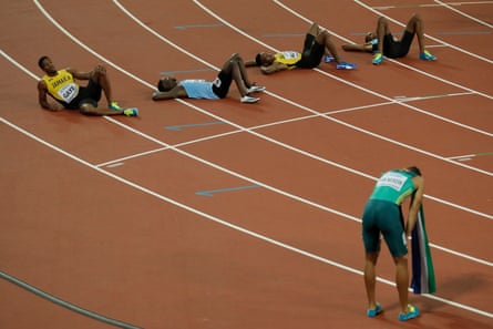 Exhausted runners lie on the track after Wayde van Niekerk had won the men’s 400m final.