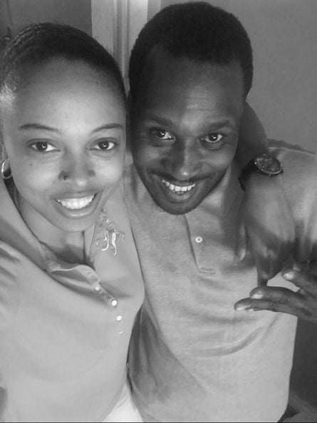 A man and a woman pose and smile