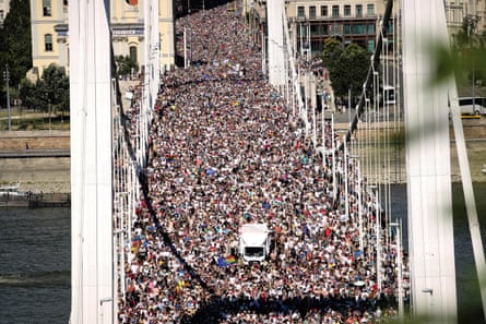 Thousands of Pride participants in the march cross the Elisabeth Bridge in Budapest, Hungary.
