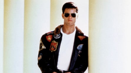 A man in black patched jacket and sunglasses.