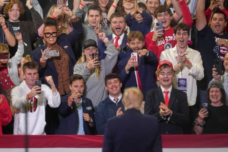 Donald Trump looks at a crowd of people cheering for him