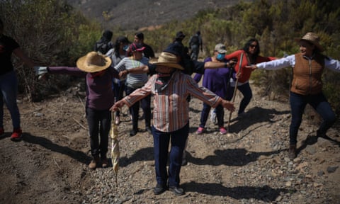 Relatives of the disappeared form a human chain to comb a suspected clandestine burial ground in the Mexican town of Ensenada last month.