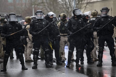 Oregon riot police stand at the scene of a protest on 6 January 2021 in Salem, Oregon.