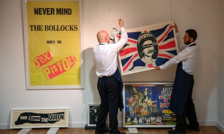 Gallery assistants put up Jamie Reid’s work as part of the Stolper-Wilson collection of Sex Pistols memorabilia in 2022.
