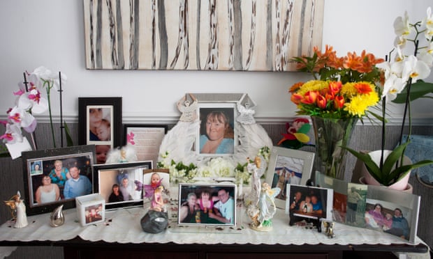 John and Ida’s photographs of Susan and family arranged on a table with a vase of flowers