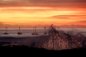 Surf boats perform a burial at sea for Anzac Day in Currumbin, Australia.