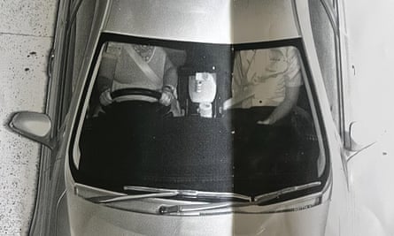 Black and white image of two people in car