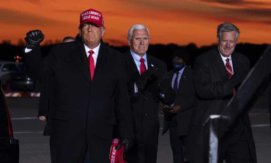 Mark Meadows, the former White House chief of staff, with Donald Trump and Mike Pence in Traverse City, Michigan in November last year.
