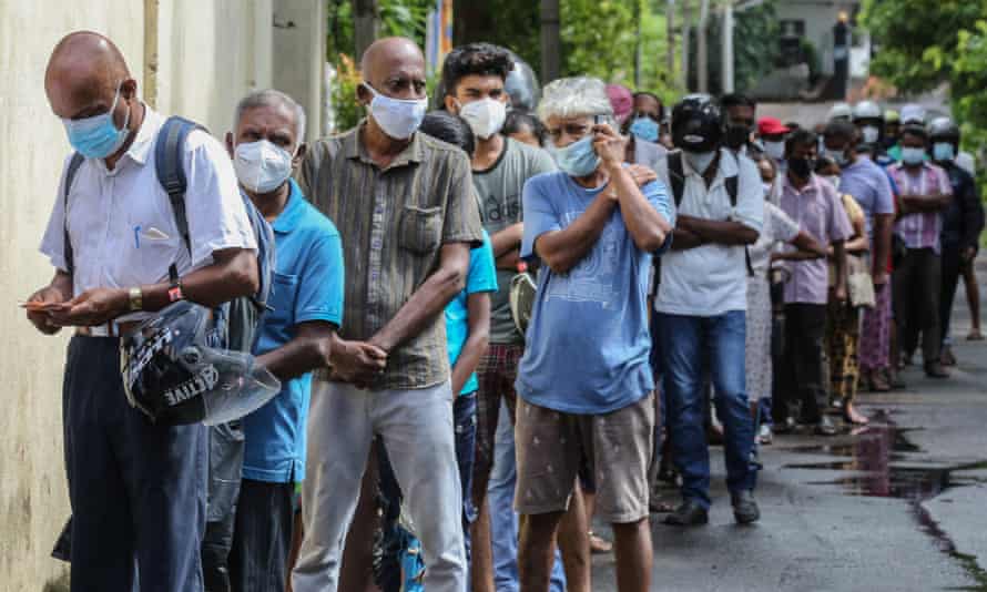 The Covid-19 pandemic led to a shortage of essential foods in Sri Lanka. People formed long lines to buy food at a state-run store in Colombo.