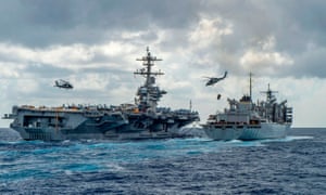 The USS Abraham Lincoln aircraft carrier receives supplies at sea
