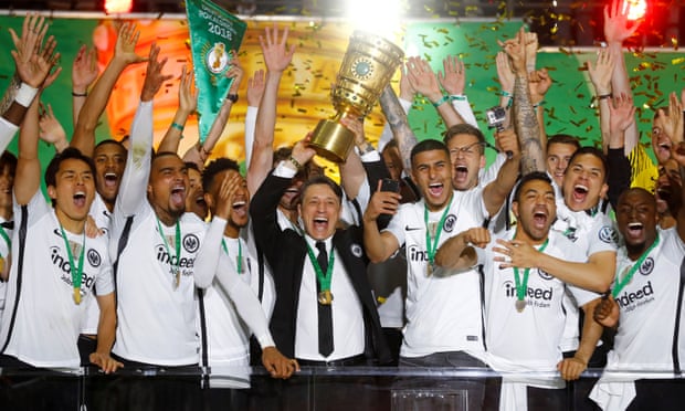 Departing manager Niko Kovac is surrounded by his Eintracht Frankfurt players as they celebrate defeating Bayern Munich 3-1 in the DFB-Pokal final in Berlin.