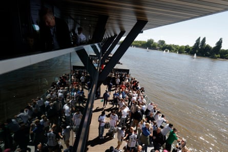 Fulham fans enjoy a drink on the concourse by the Thames.
