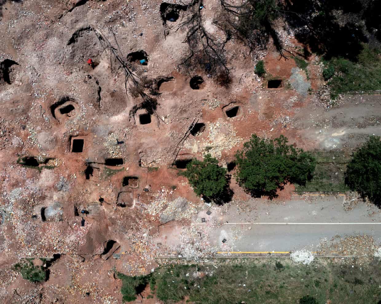 Aerial view of illegal mining pits dug where the road once was