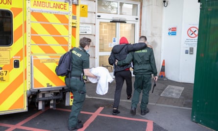 Ambulance workers help a patient at King’s College hospital.