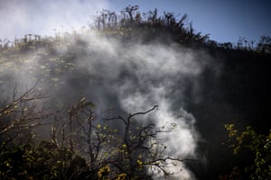 Smoke rises from a fire burning off some of the masses of debris left by the storm.