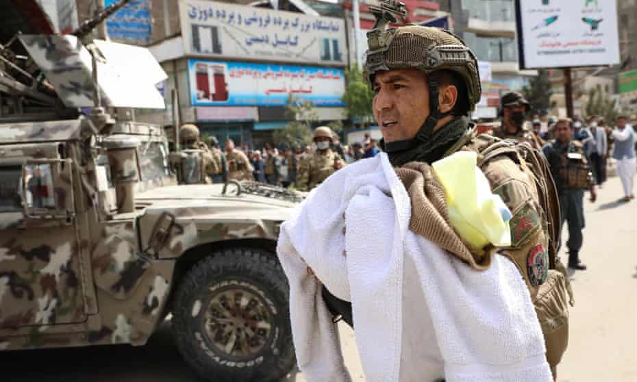An Afghan soldier removes a baby from the hospital in Kabul.