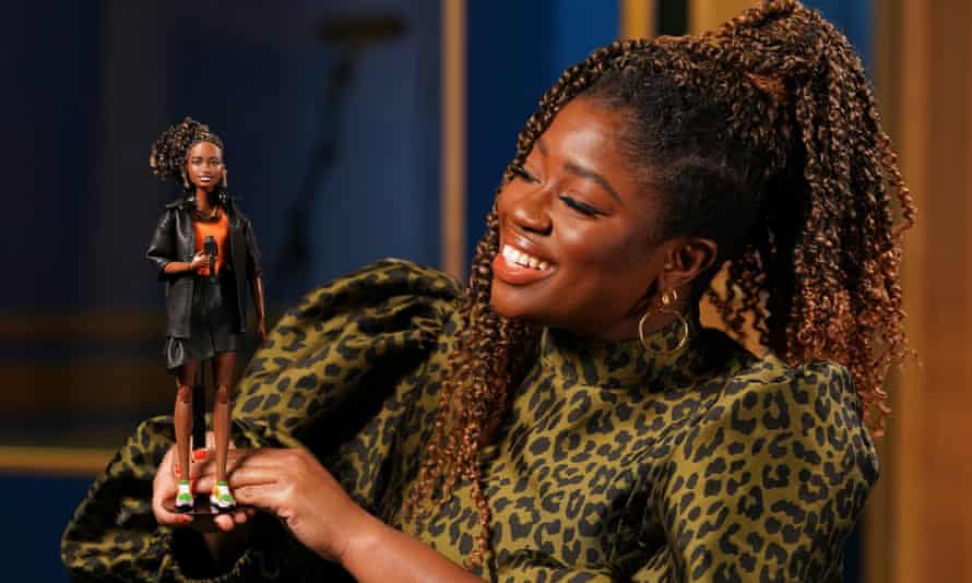 BBC Radio 1 DJ Clara Amfo holding the Barbie doll created in her likeness