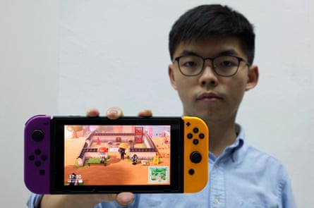 Pro-democracy activist Joshua Wong poses with the game Animal Crossing on Nintendo Switch in Hong Kong.