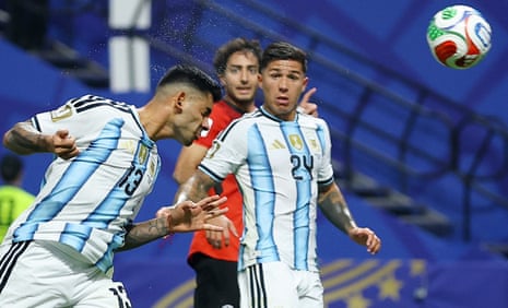 Argentina's Cristian Romero heads home.