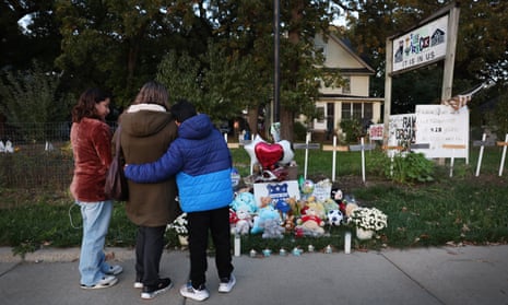 People visit a memorial in front of the home where Wadea Al-Fayoume was stabbed to death in Plainfield, Illinois. 