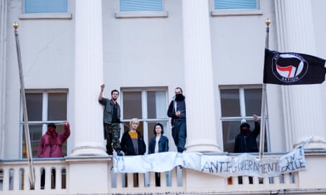 Members of the Autonomous Nation of Anarchist Libertarians on the balcony of the Eaton Square property.