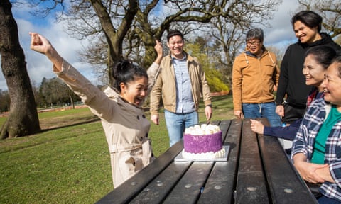 Allyssa Bravo, left, a nurse, with her fiance, Paul Abuston, second left, celebrate her 27th birthday in Cannon Hill park in Birmingham with family members.