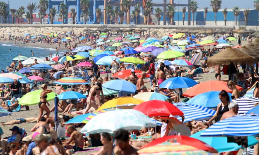 People enjoy a day at La Malagueta beach, Málaga.