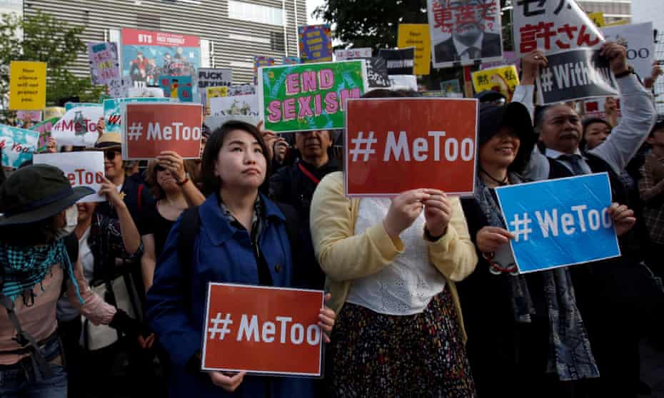 Protesters hold placards during a rally against harassment in Tokyo