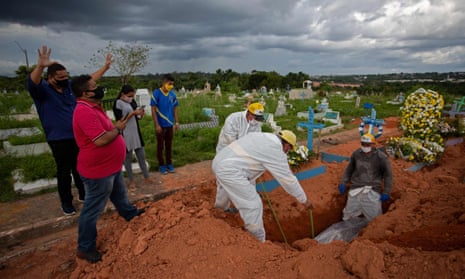 Relatives pray during the funeral of a 57-year-old Covid victim at the Nossa Senhora Aparecida cemetery in Manaus, Brazil.