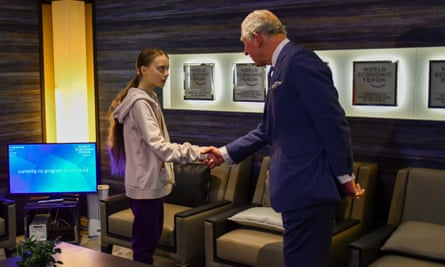 Prince Charles shakes hands with the climate activist Greta Thunberg in Davos.
