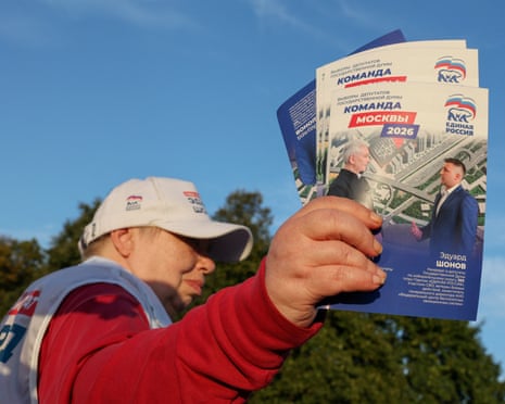 A volunteer handing out flyers for a United Russia candidate in Moscow.