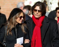 The pair are dressed in black apart from Damian's bright red scarf