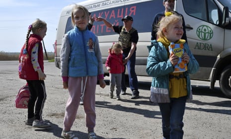 Children wait for boarding a transport during an evacuation of civilians on a road near Slovyansk, eastern Ukraine.
