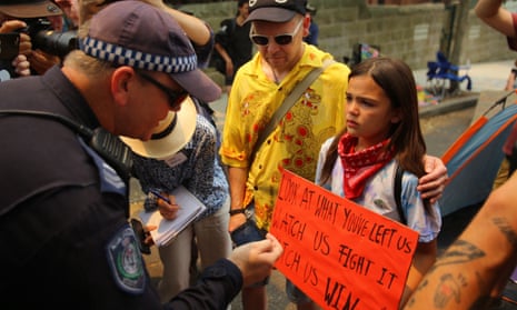 A policeman talks to Izzy Raj-Seppings during a protest outside Kirribilli House in Sydney