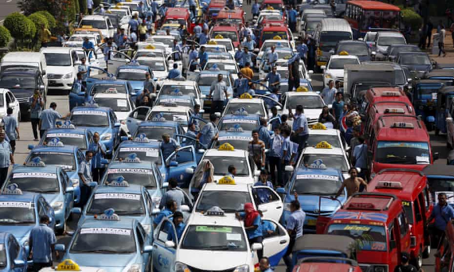 Taxis taking part in a protest rally to demand the government prohibits ride-hailing apps in Jakarta.