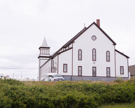 exterior of church in rural area surrounded by grass and shrubs