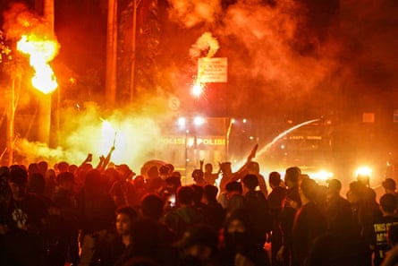 Anti-riot police disperse protesters during a demonstration against a revision to the armed forces law in Jakarta in March.