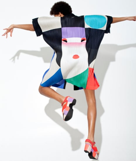 A multi-coloured square-shaped Issey Miyake top on a dancing woman