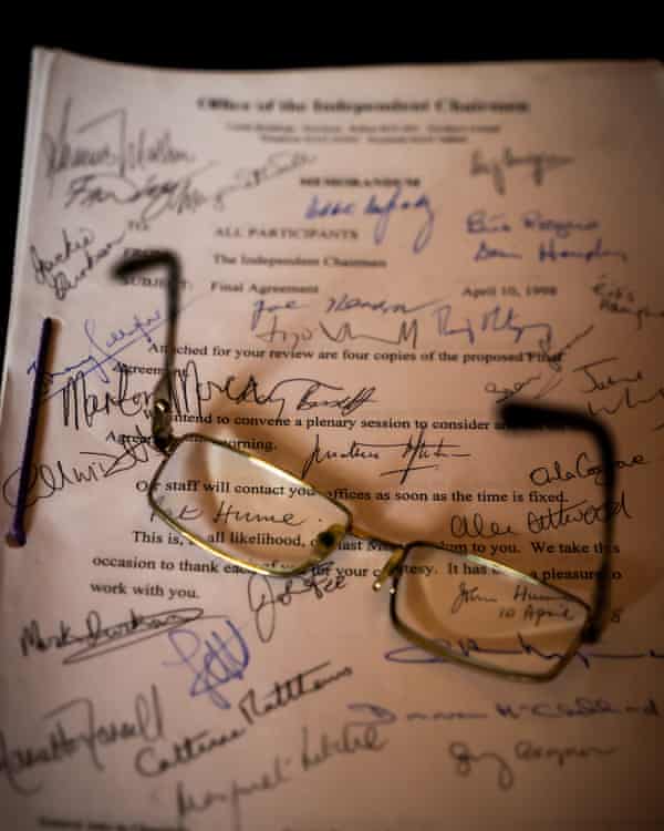 Spectacles belonging to John Hume atop a signed copy of the Good Friday agreement