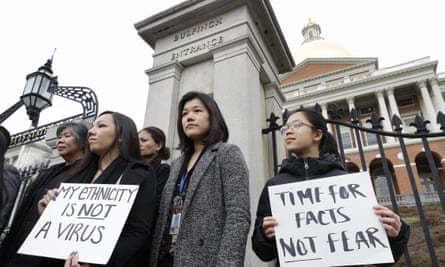 Jessica Wong, front left, Jenny Chiang, center, and Sheila Vo, all from the Massachusetts Asian American Commission, condemn racism aimed at Asian communities during the pandemic on 12 March.